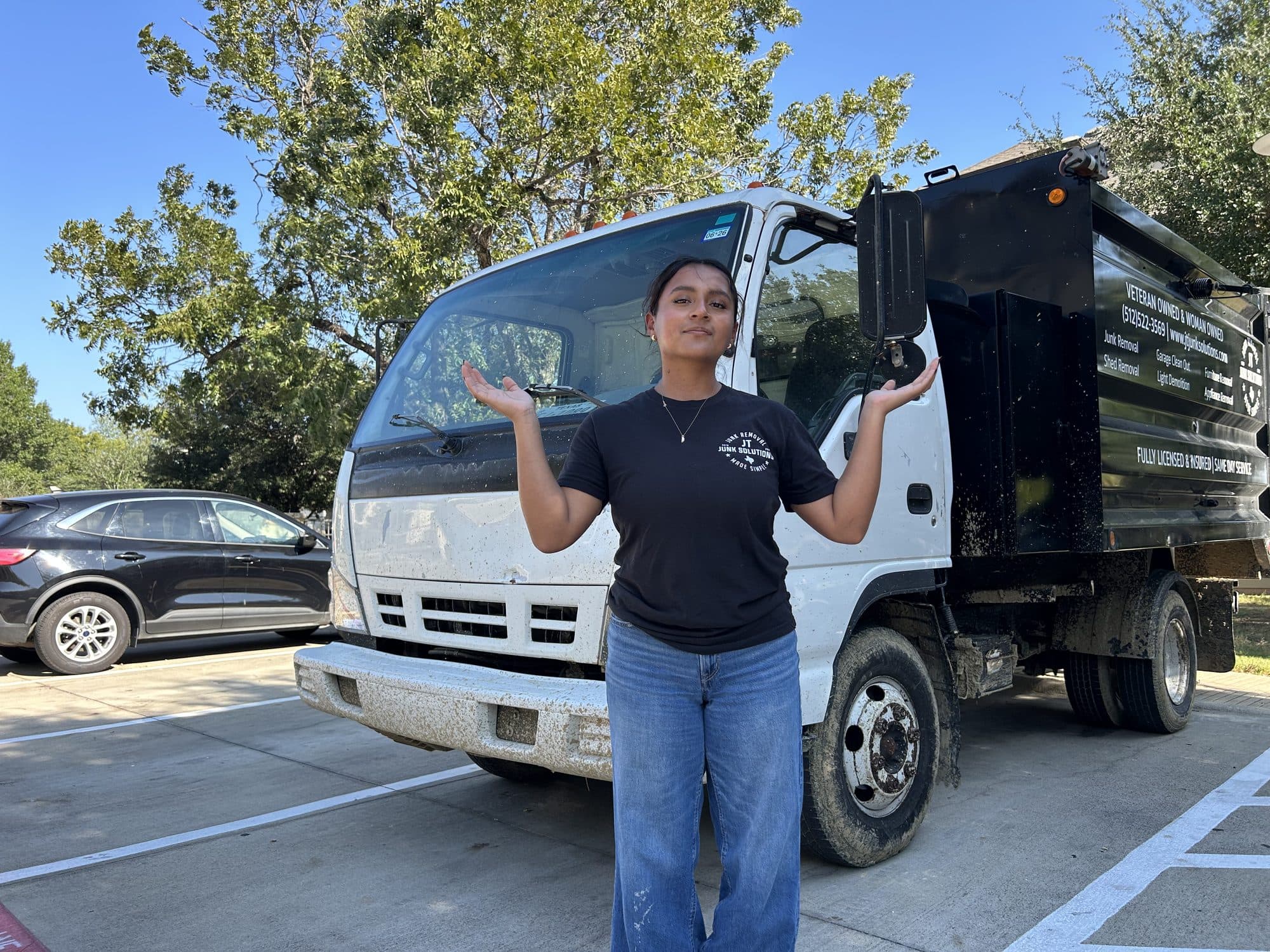 Jackie, co-owner of JT Junk Solutions, standing in front of the JT truck